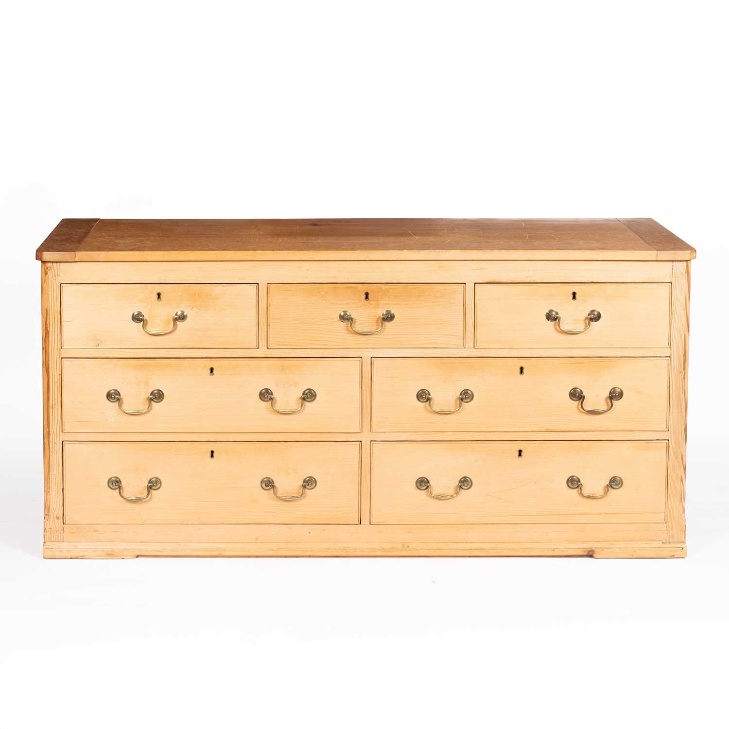 Lot 22 - A large pine chest of drawers