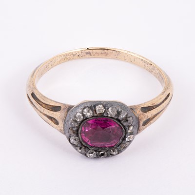 Lot 17 - A ruby and diamond cluster ring