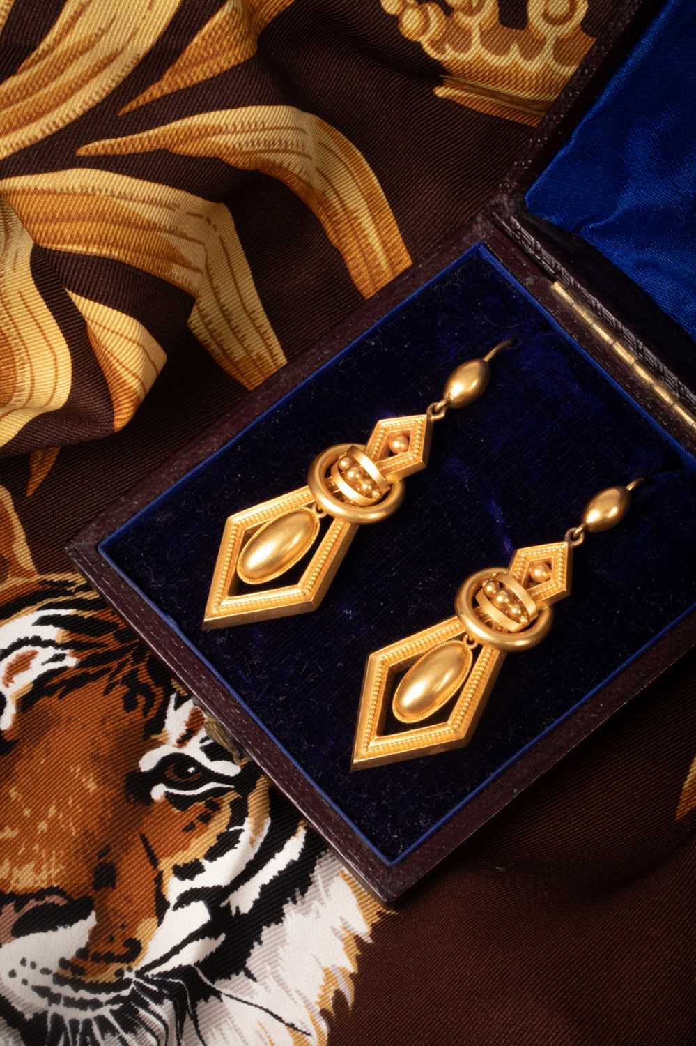 Lot 104 - A pair of Victorian yellow metal drop earrings