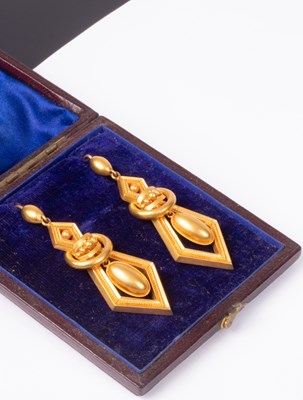 Lot 104 - A pair of Victorian yellow metal drop earrings