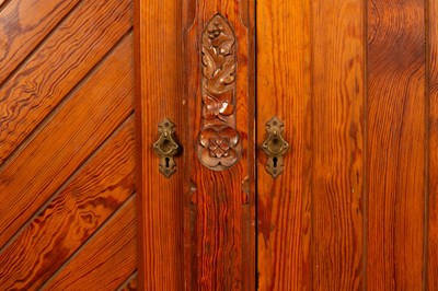 Lot 348 - An Aesthetic movement pitch pine triple wardrobe